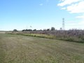 High tension wires to W running parallel to runway